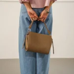 Women's Taupe Braided Top Handle Bag | Pebbled Leather with Gold Hardware | Shoulder & Crossbody thumbnail