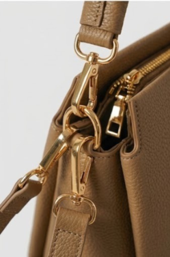 Gleaming gold zip hardware and clip fittings throughout