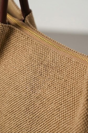 Richly textured woven beige textile body